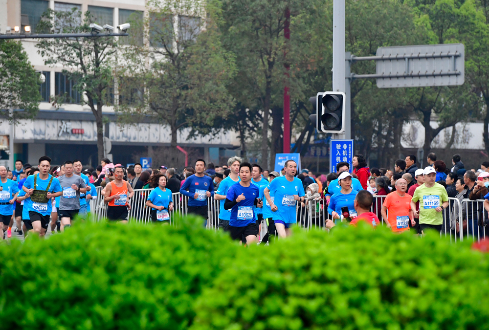 參加半程馬拉松的運動員正在相互追趕。眉山日報全媒體記者 廖波 攝 (3).jpg